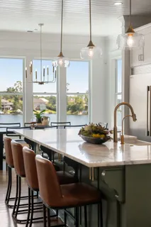 a dining room with furniture a chandelier and wooden floor
