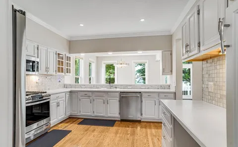 a kitchen with stainless steel appliances granite countertop a stove and a sink