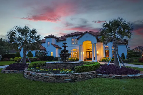 a front view of a house with garden and patio