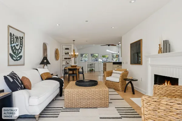 a living room with furniture fireplace and rug