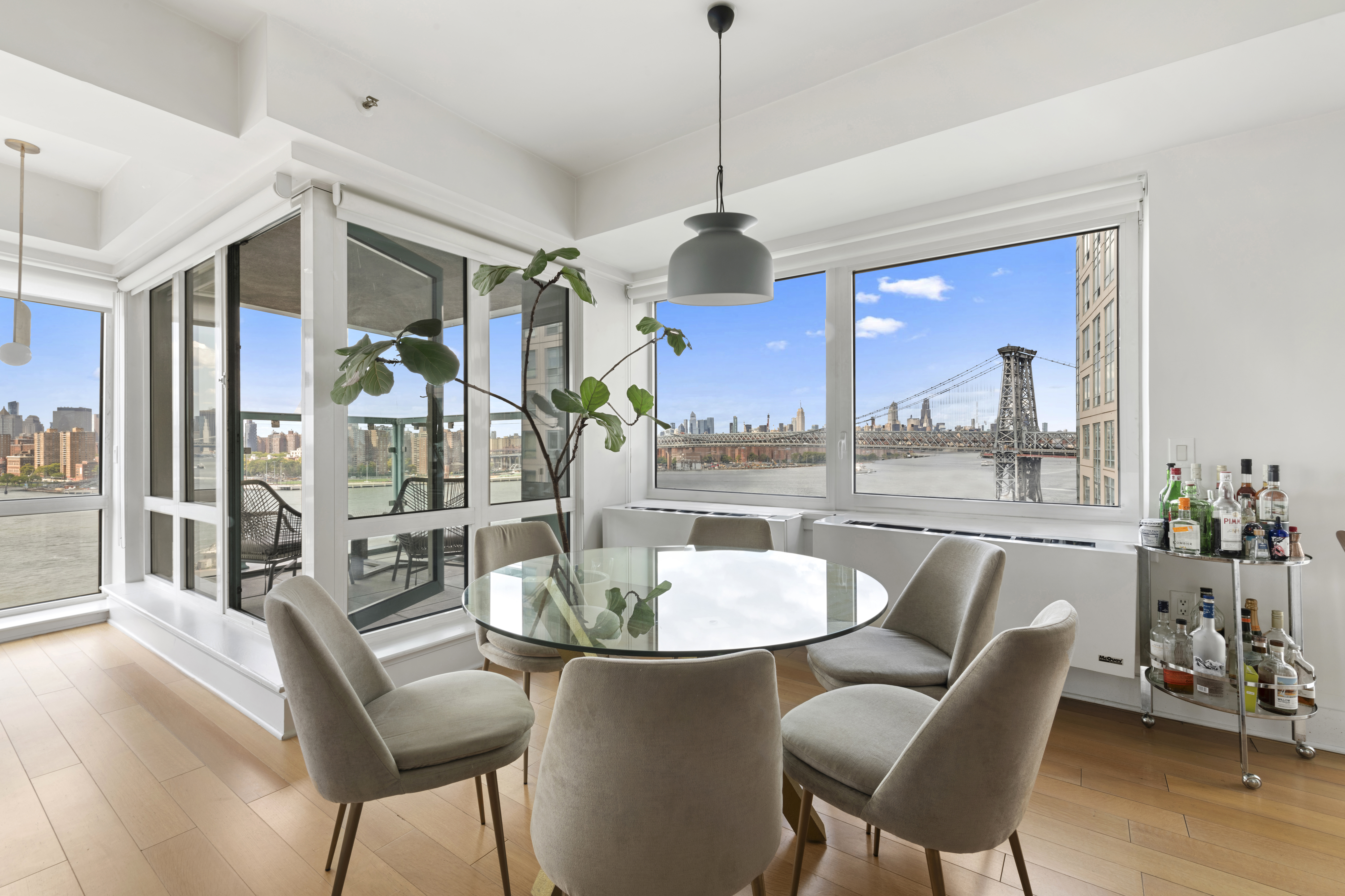 446 Kent Avenue, Unit 14A Brooklyn, NY 11249 - Photo 5 of 19 a dining room with furniture a chandelier and wooden floor