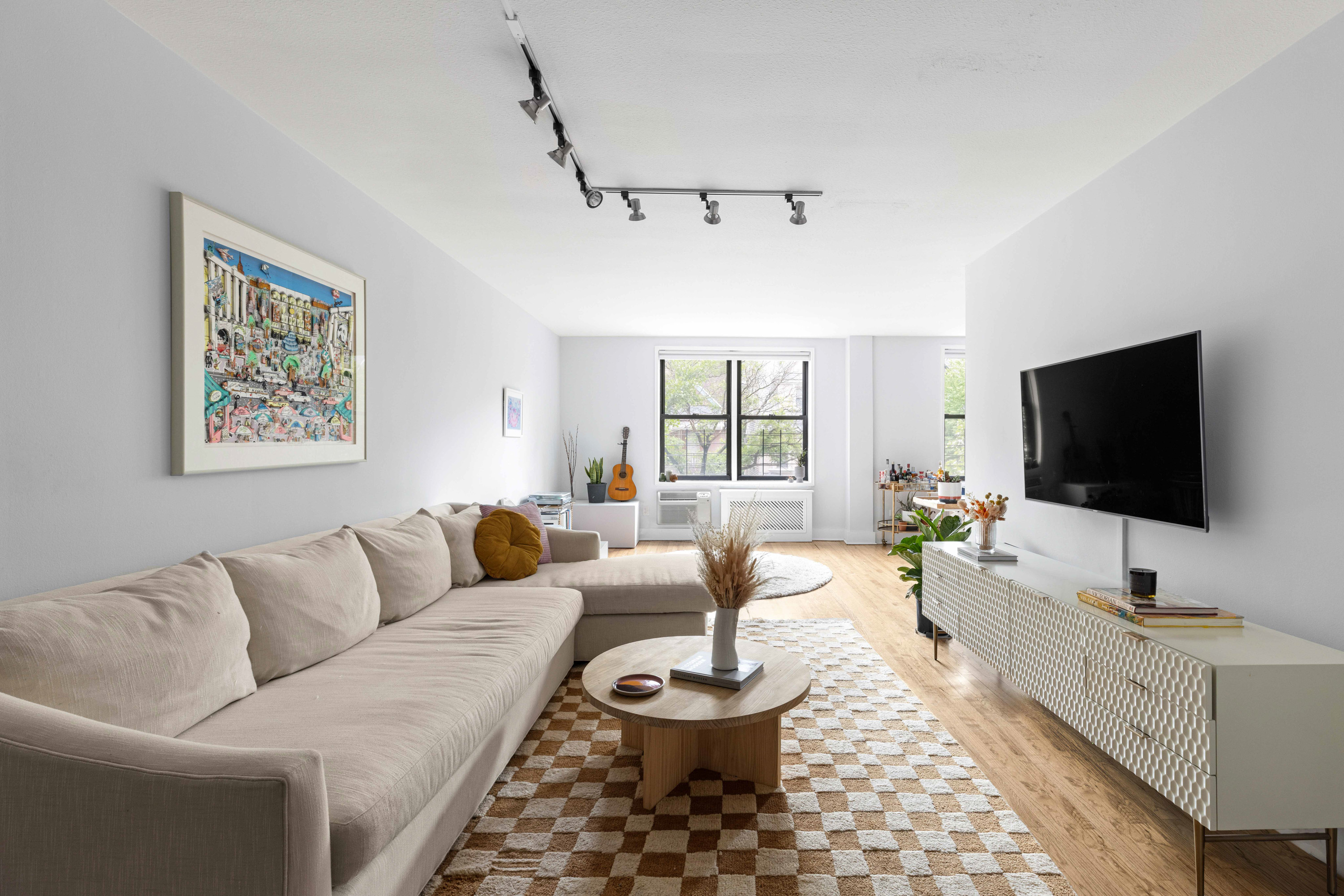 599 East 7th Street, Unit 2F Brooklyn, NY 11218 - Photo 1 of 12 a living room with furniture and a flat screen tv