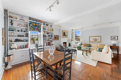 a living room with furniture and a bookshelf