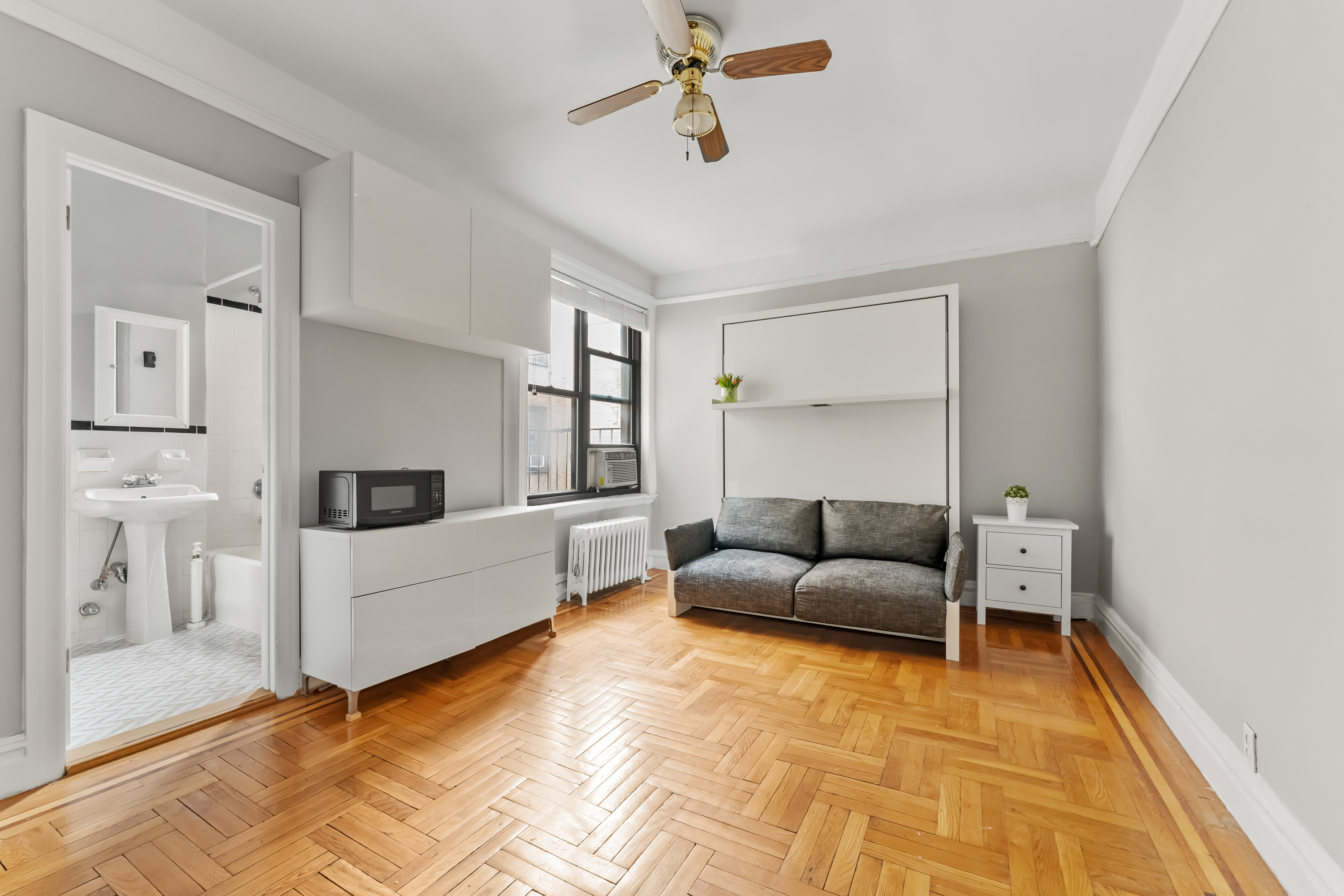 345 East 77th Street, Unit 4I Manhattan, NY 10075 - Photo 2 of 4 a living room with furniture and white walls