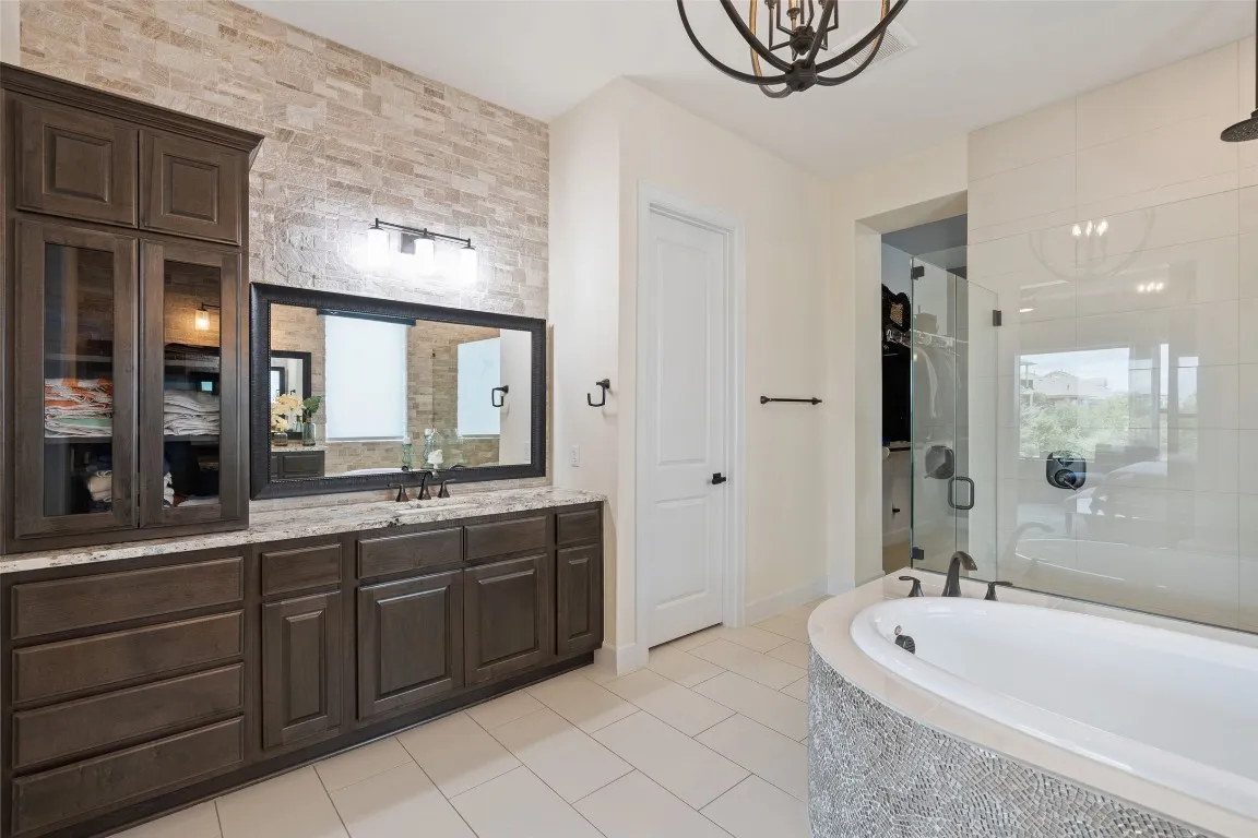 a bathroom with a tub sink and mirror