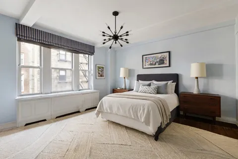 a bedroom with a large bed and a window