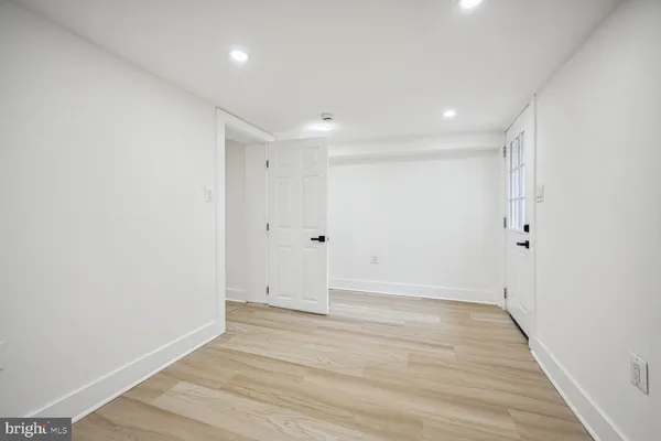 a view of room with wooden floor