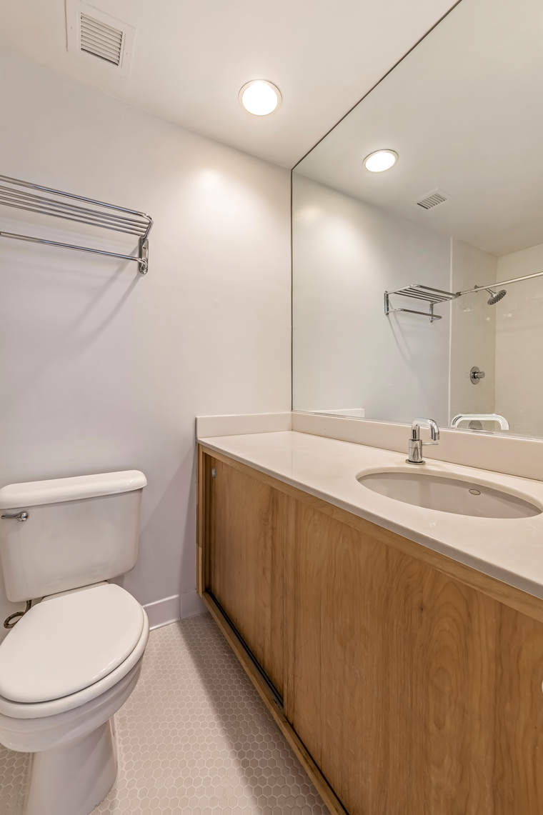 2 Cornelia Street, Unit 306 Manhattan, NY 10014 - Photo 10 of 13 a bathroom with a sink a toilet and a mirror