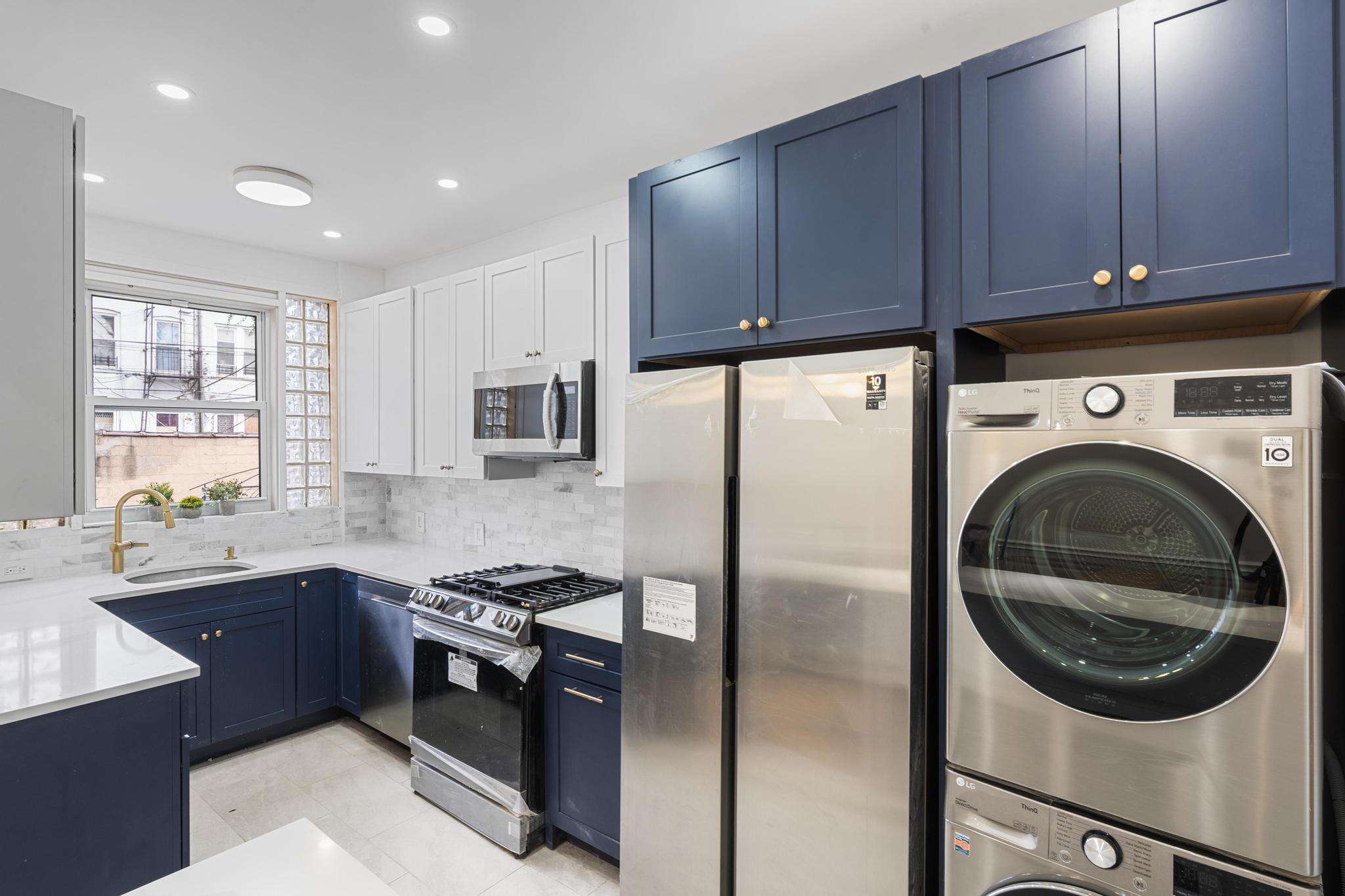 237 Remsen Avenue, Unit 1 Brooklyn, NY 11212 - Photo 3 of 16 a kitchen with stainless steel appliances granite countertop a sink a stove a refrigerator cabinets and a window