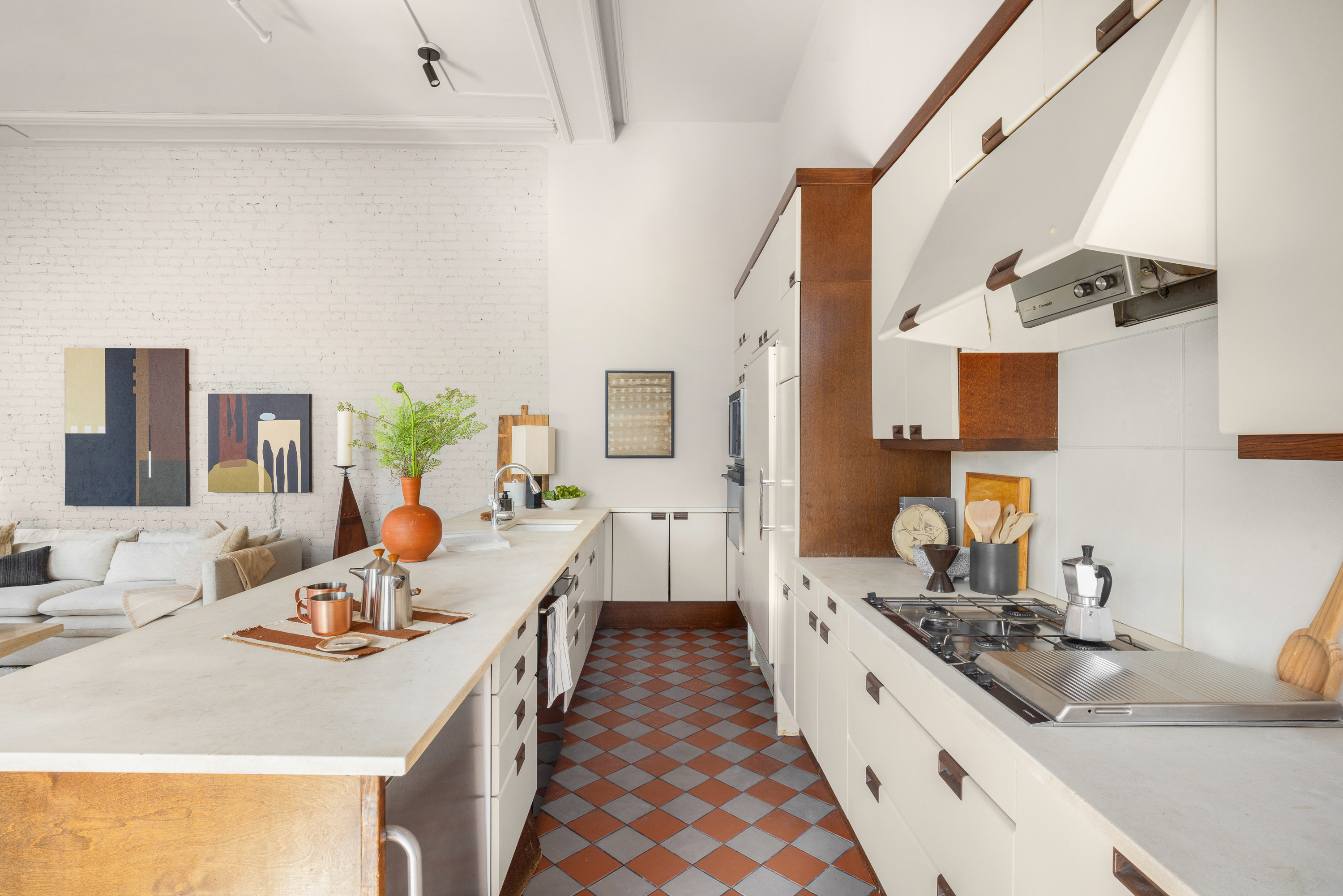 874 Broadway, Unit 501 Manhattan, NY 10003 - Photo 10 of 17 a large white kitchen with a stove and a sink