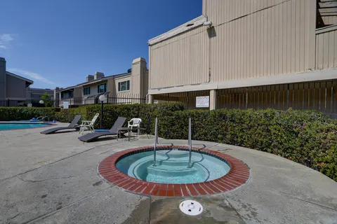 a view of a house with backyard porch and furniture