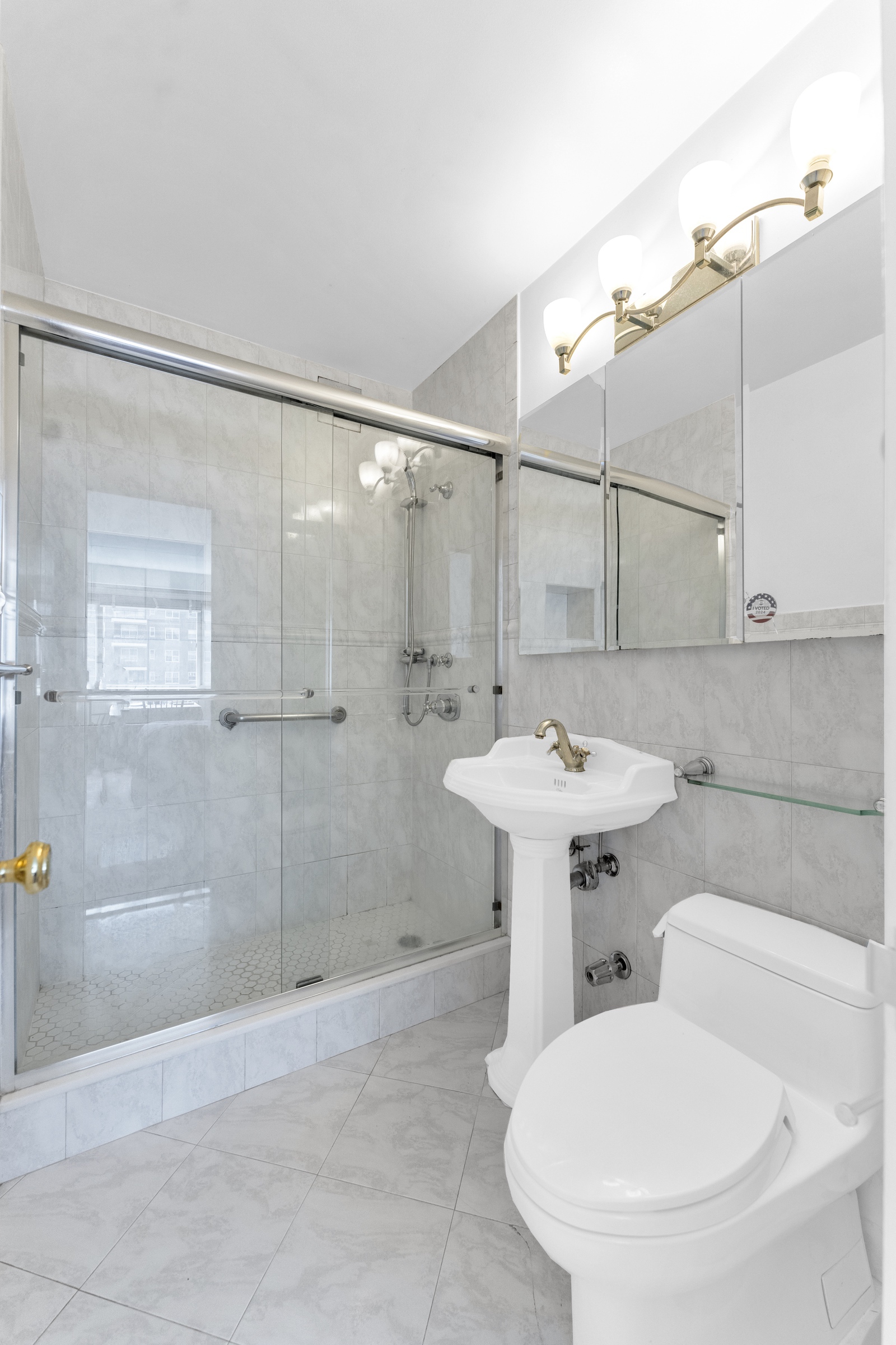 2621 Palisade Avenue, Unit 11J Bronx, NY 10463 - Photo 14 of 19 a bathroom with a sink toilet and shower