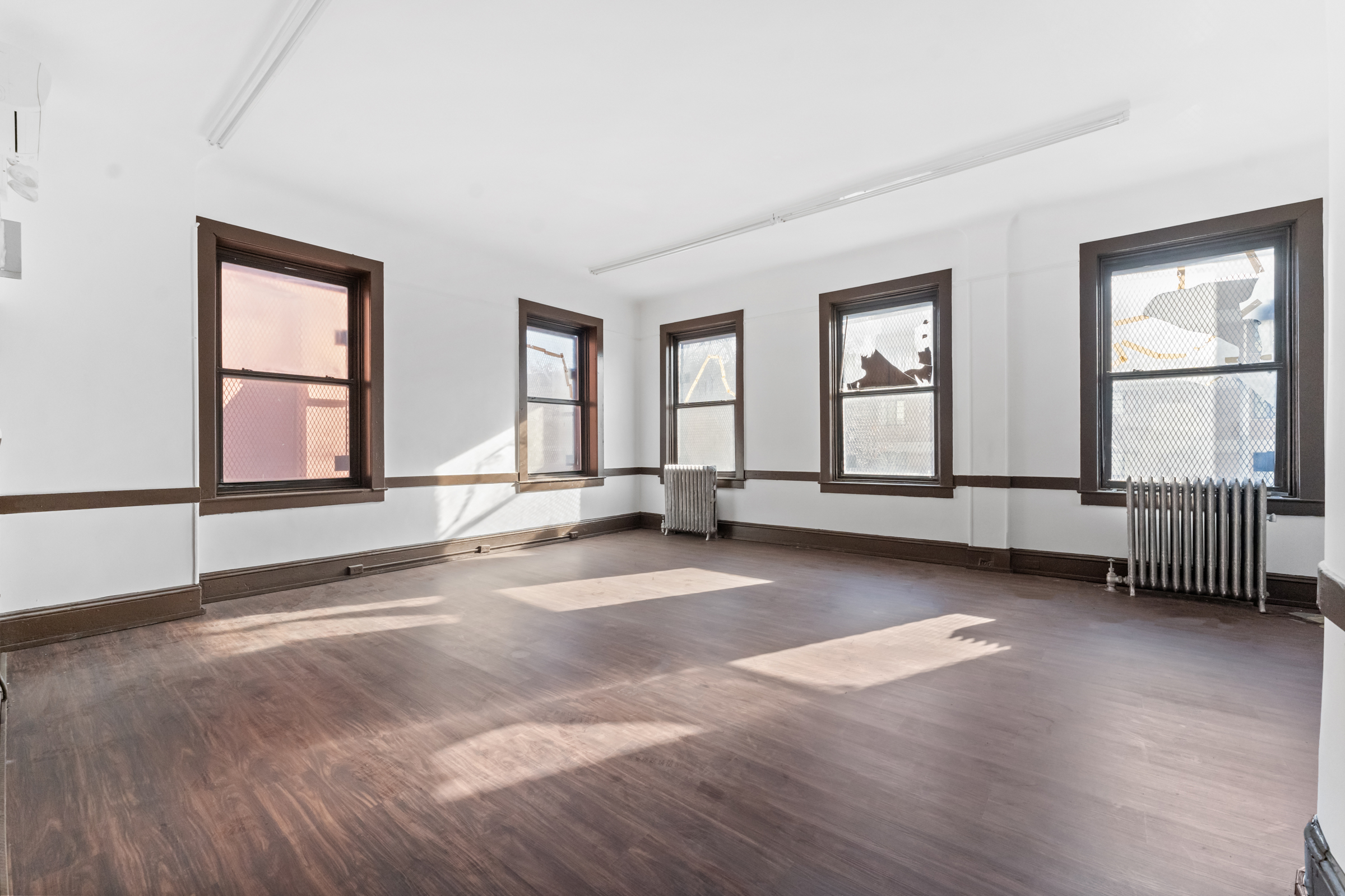 187 Maujer Street Brooklyn, NY 11206 - Photo 8 of 12 a view of an empty room with glass door and windows