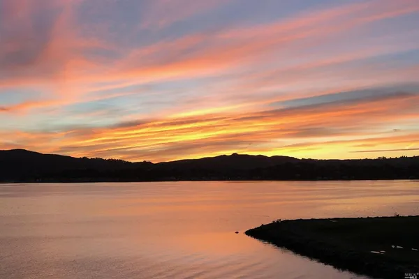 a view of lake with sunset