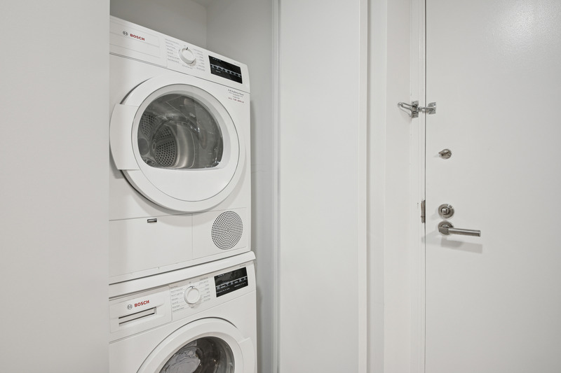 100 West 58th Street, Unit 5E Manhattan, NY 10019 - Photo 9 of 12 a utility room with dryer and washer