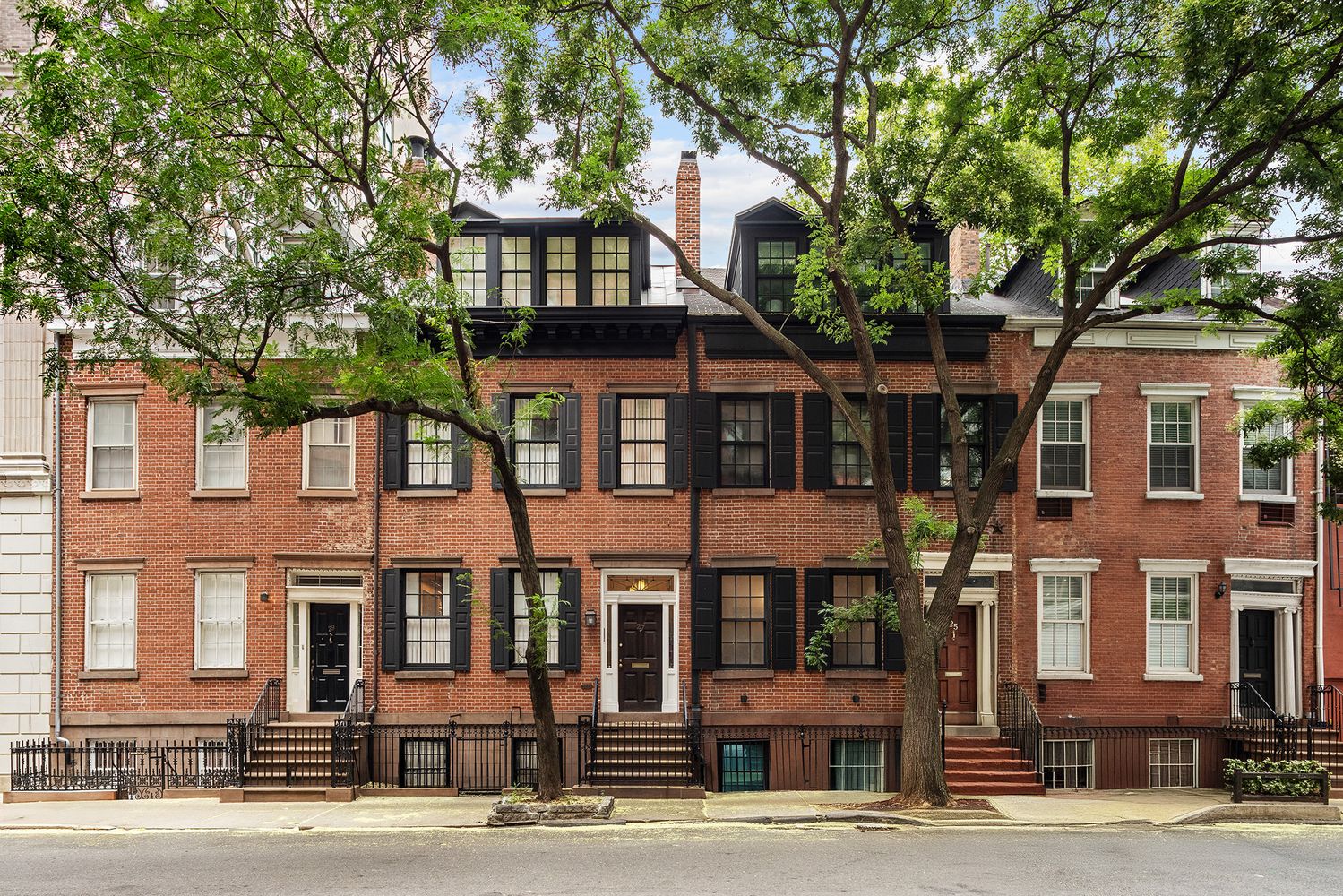 a front view of a residential apartment building with a yard