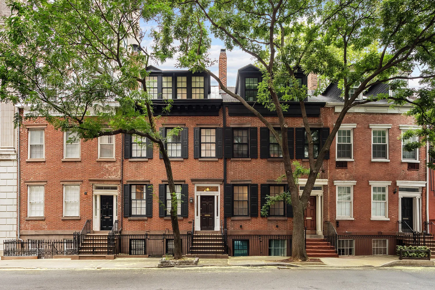 a front view of a residential apartment building with a yard