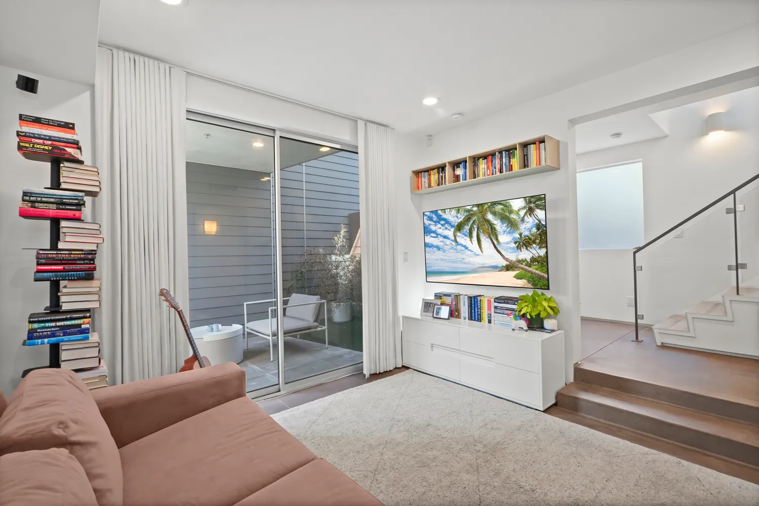 a living room with furniture and a book shelf