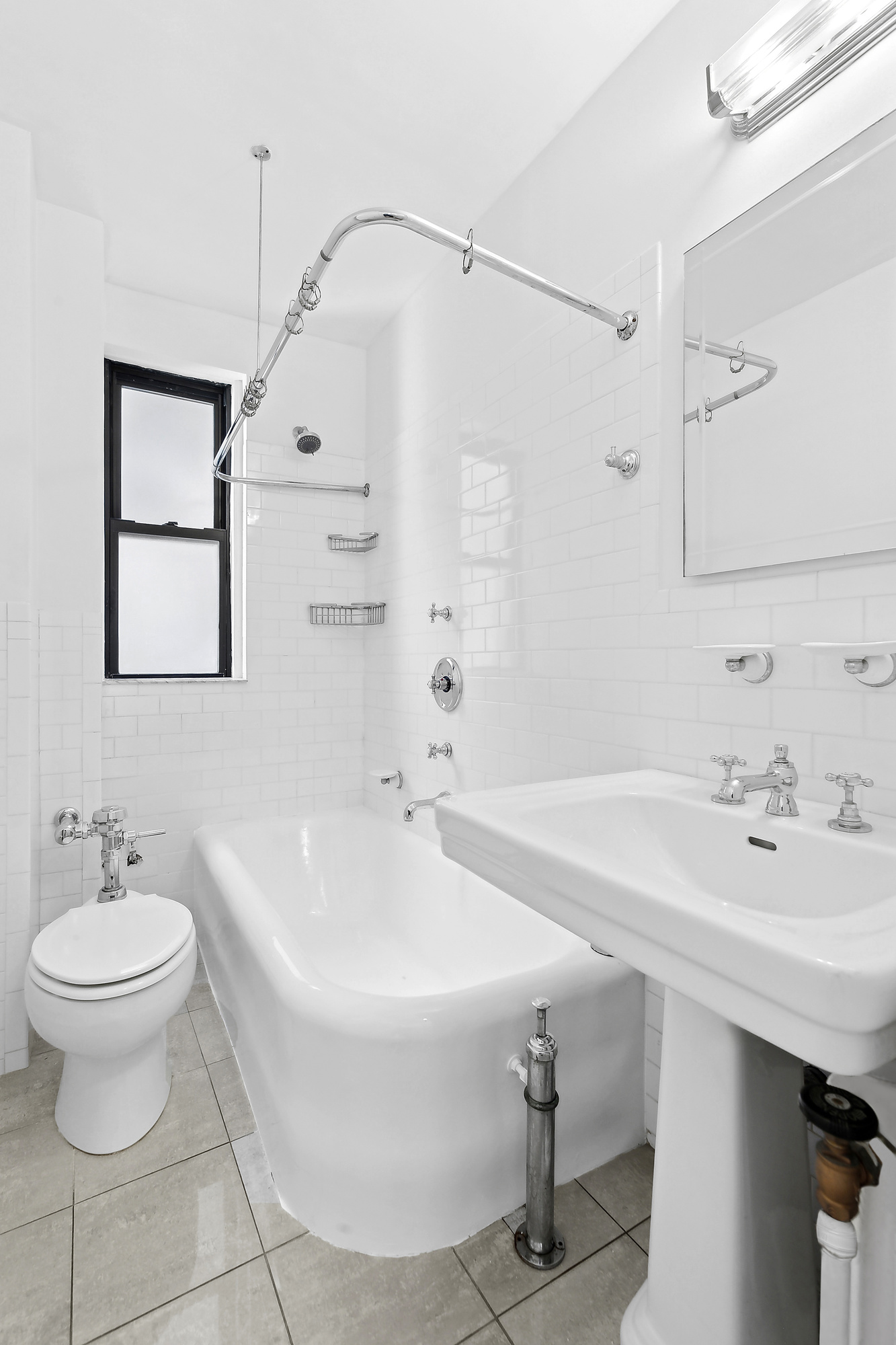 230 West End Avenue, Unit 5B Manhattan, NY 10023 - Photo 5 of 6 a bathroom with a sink a toilet and a mirror