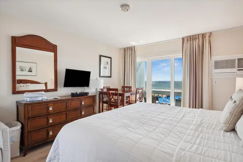 a bedroom with bed and large window