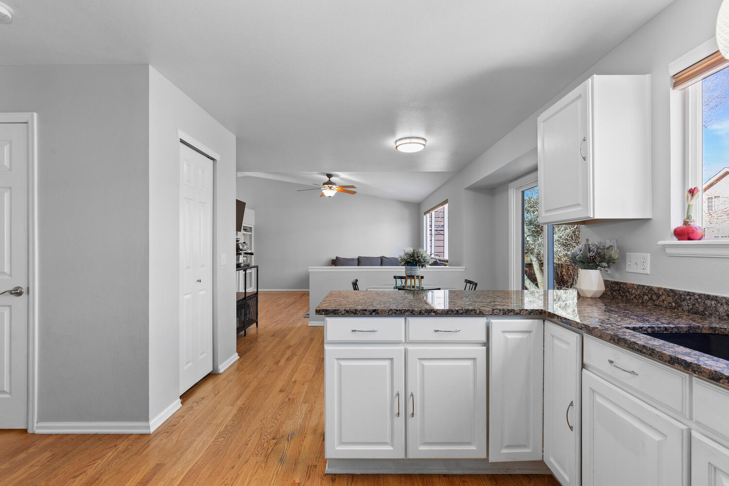 847 Timbervale Trail Highlands Ranch, CO 80129 - Photo 11 of 36 a kitchen with granite countertop a sink stainless steel appliances and cabinets