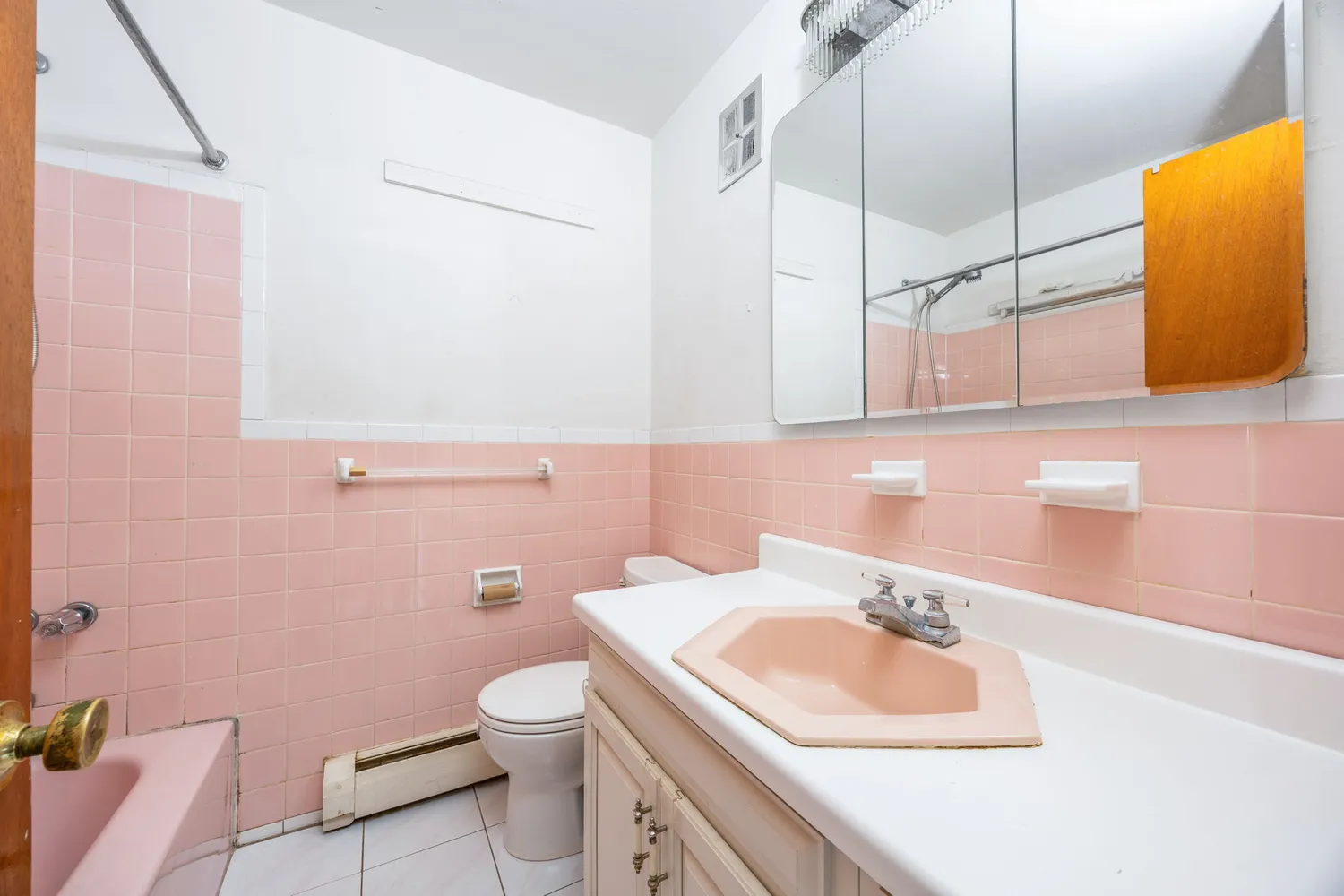 a bathroom with a sink a toilet and mirror