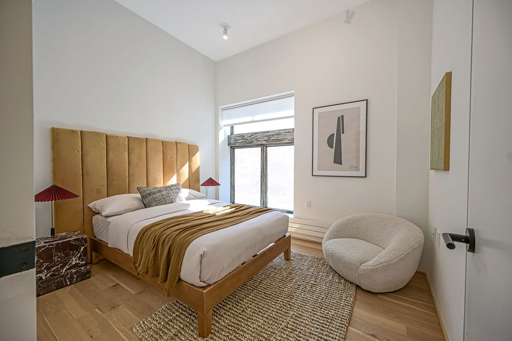 459 Harman Street, Unit 1 Manhattan, NY 10026 - Photo 10 of 17 a bedroom with a bed and wooden floor