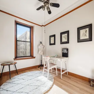 a dining room with wooden floor and a window