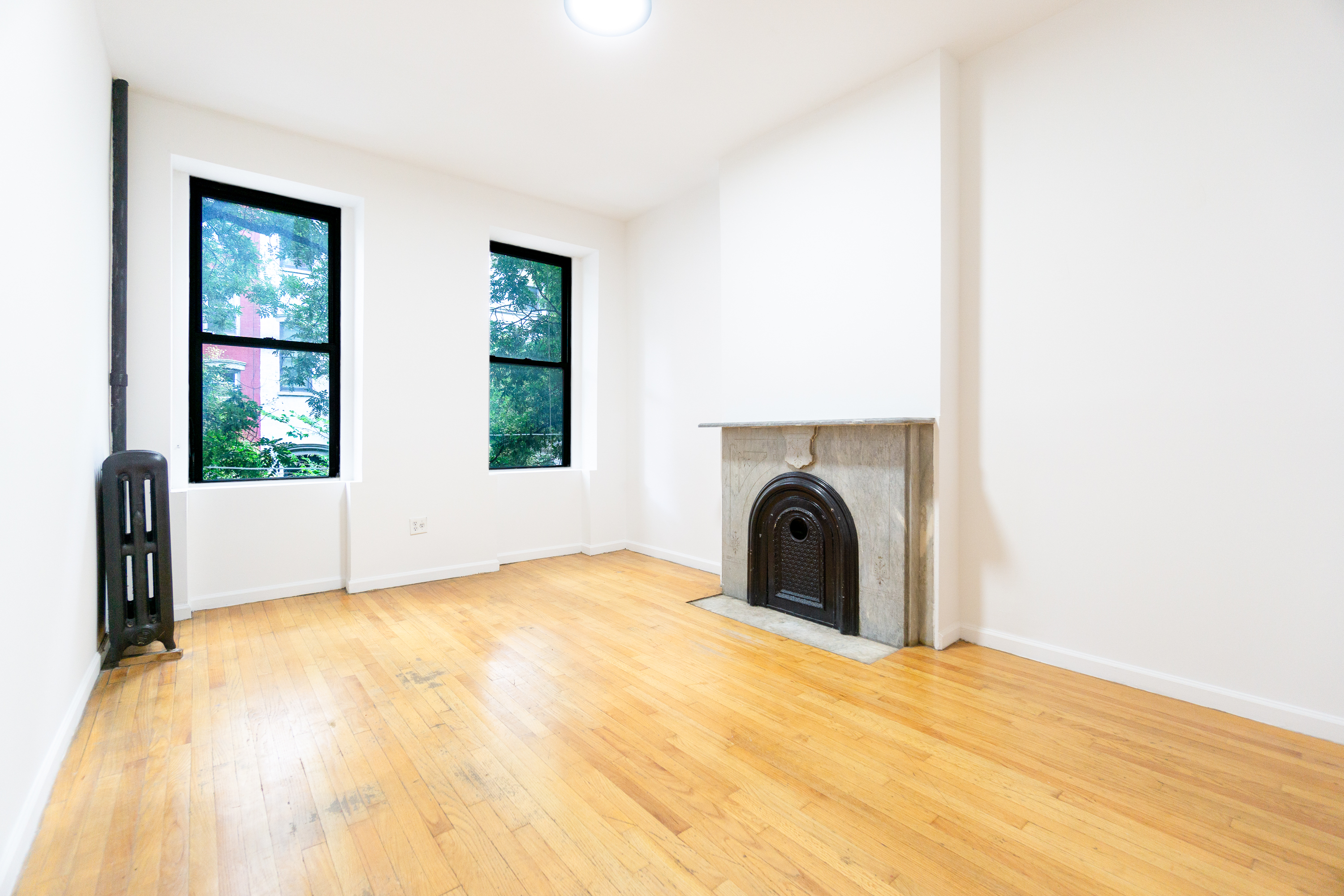 215 East 5th Street, Unit 3 Manhattan, NY 10003 - Photo 2 of 25 a view of a bedroom with a bed and a window