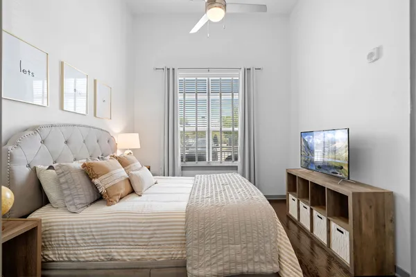 a bedroom with a bed and a window