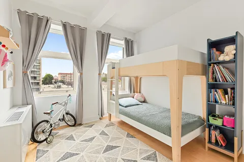 a bedroom with large window and a walk in closet
