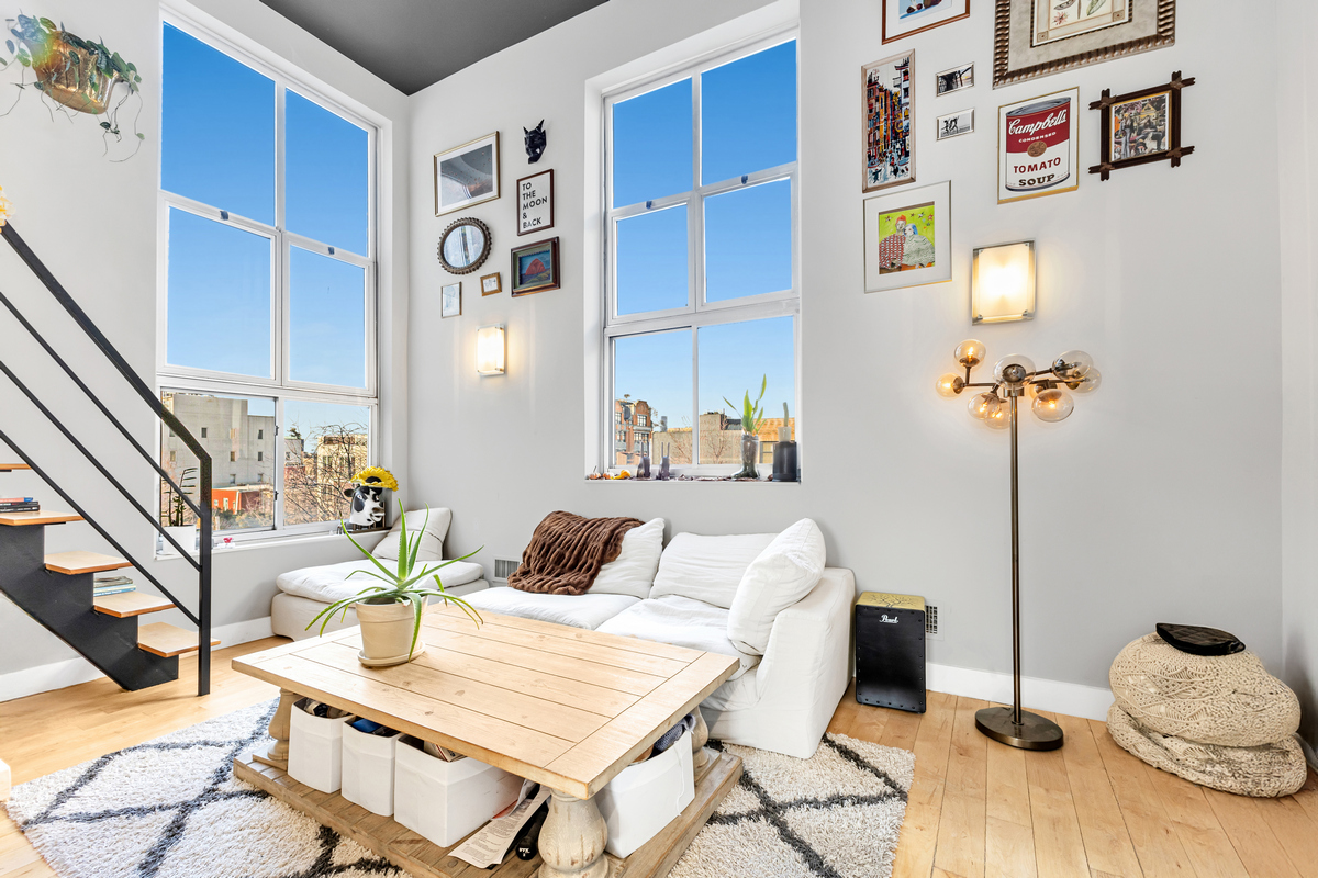 a bedroom with furniture and a wooden floor