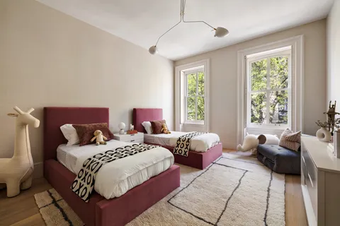 a bed room with two beds and a couch