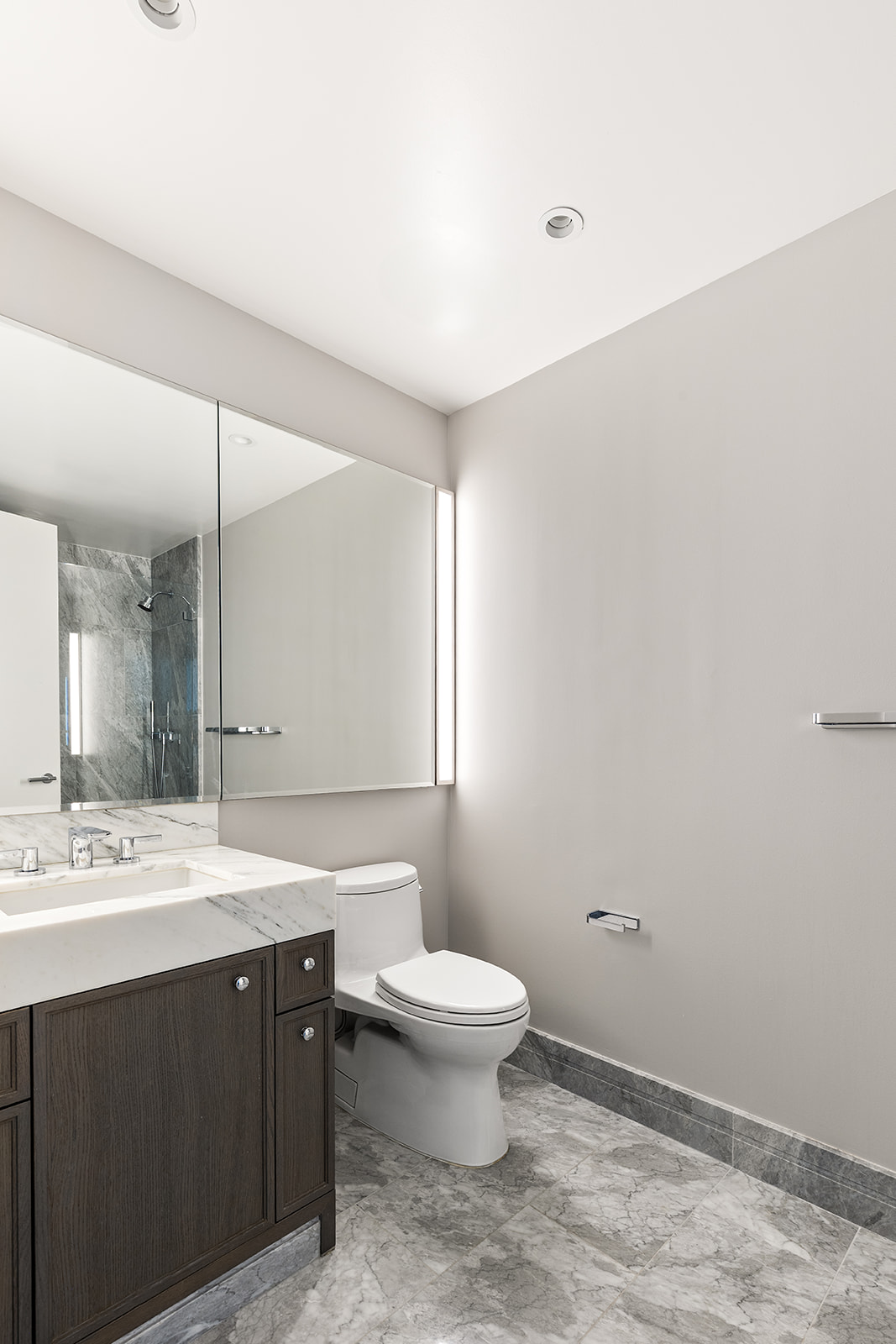 10 Riverside Boulevard, Unit 30B Manhattan, NY 10069 - Photo 8 of 19 a bathroom with a sink a toilet a mirror and vanity