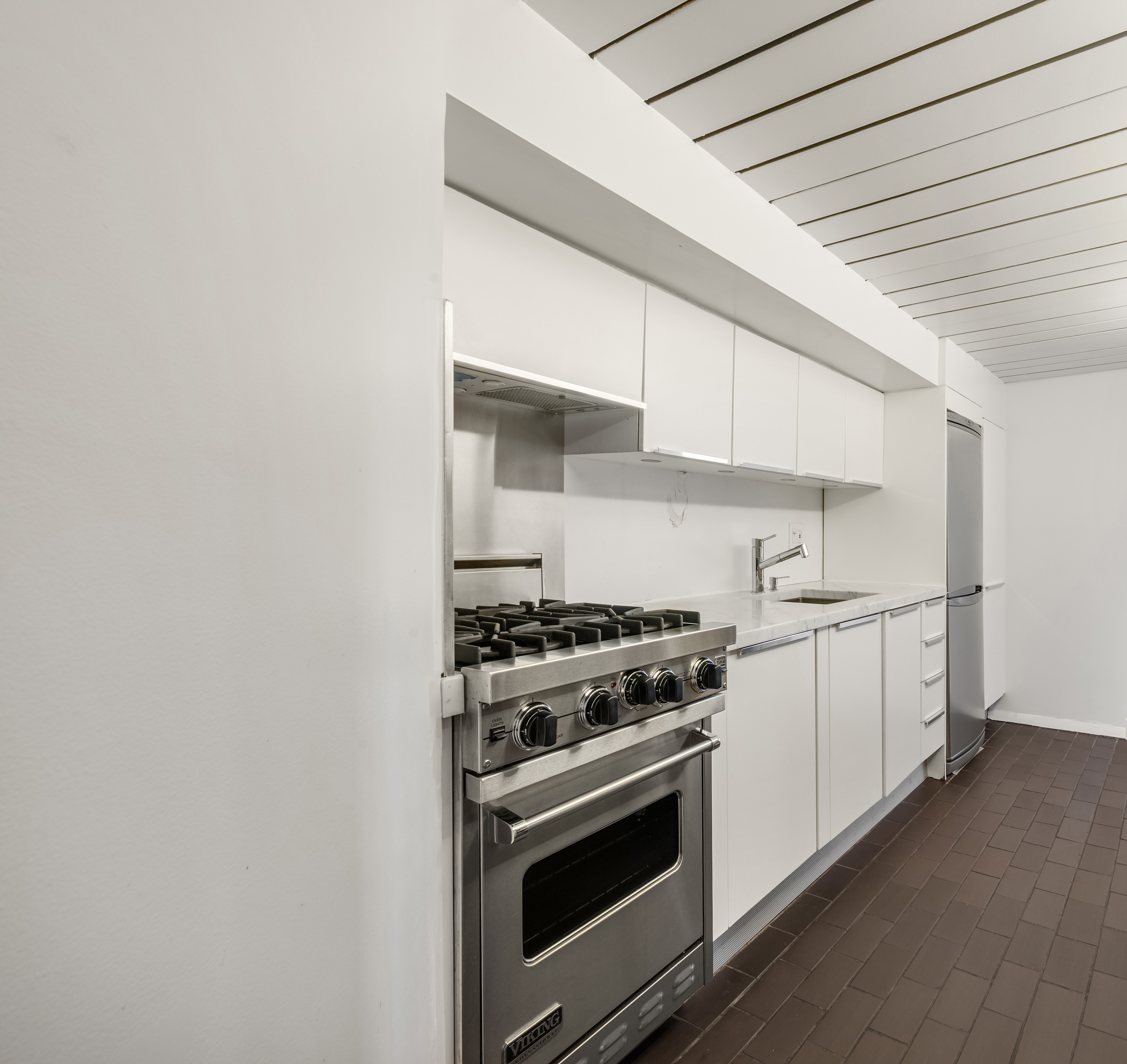 421 Hudson Street, Unit 504 Manhattan, NY 10014 - Photo 10 of 13 a kitchen with a stove and a microwave