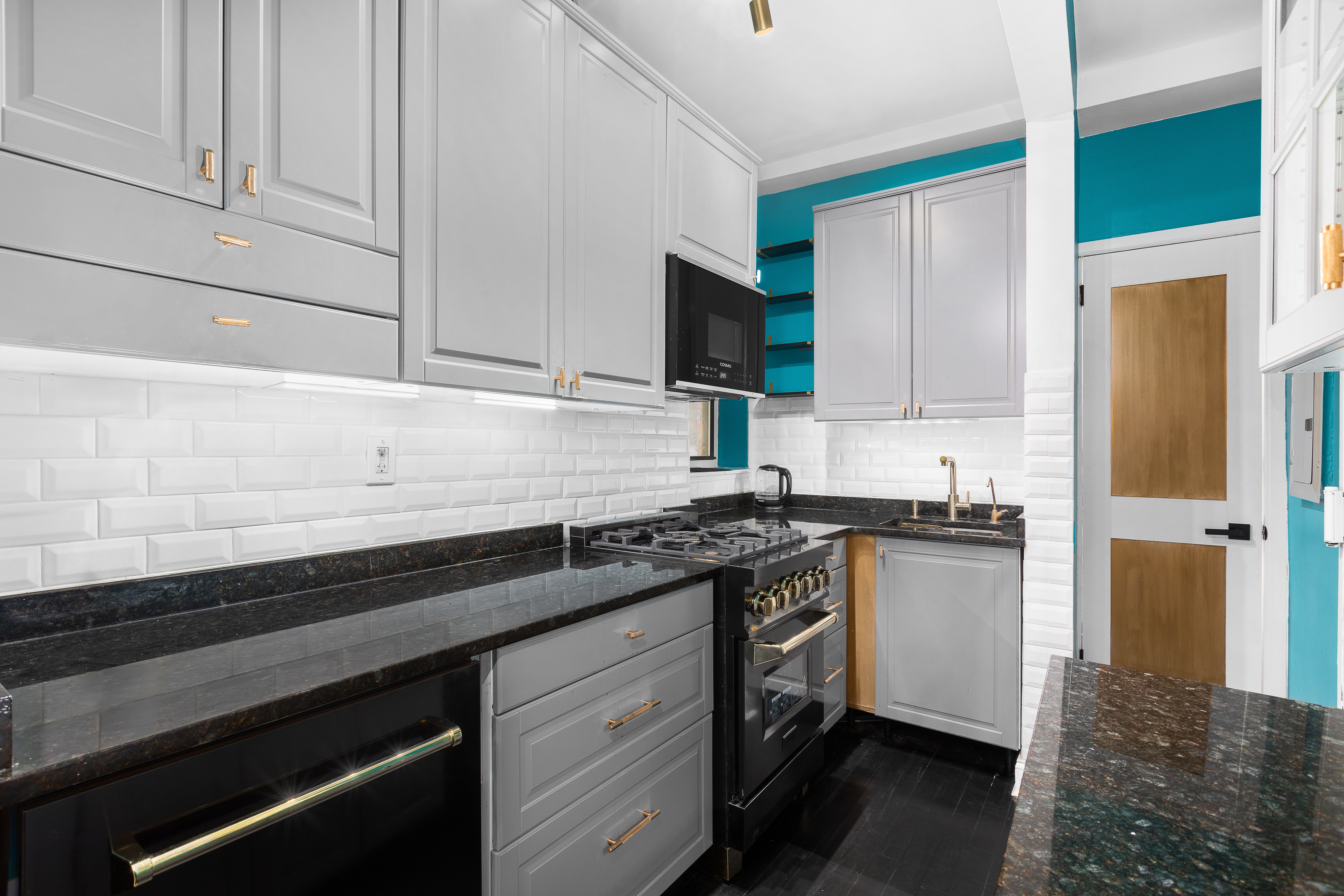 786 9th Avenue, Unit 2FN Manhattan, NY 10019 - Photo 2 of 6 a kitchen with granite countertop white cabinets and stainless steel appliances
