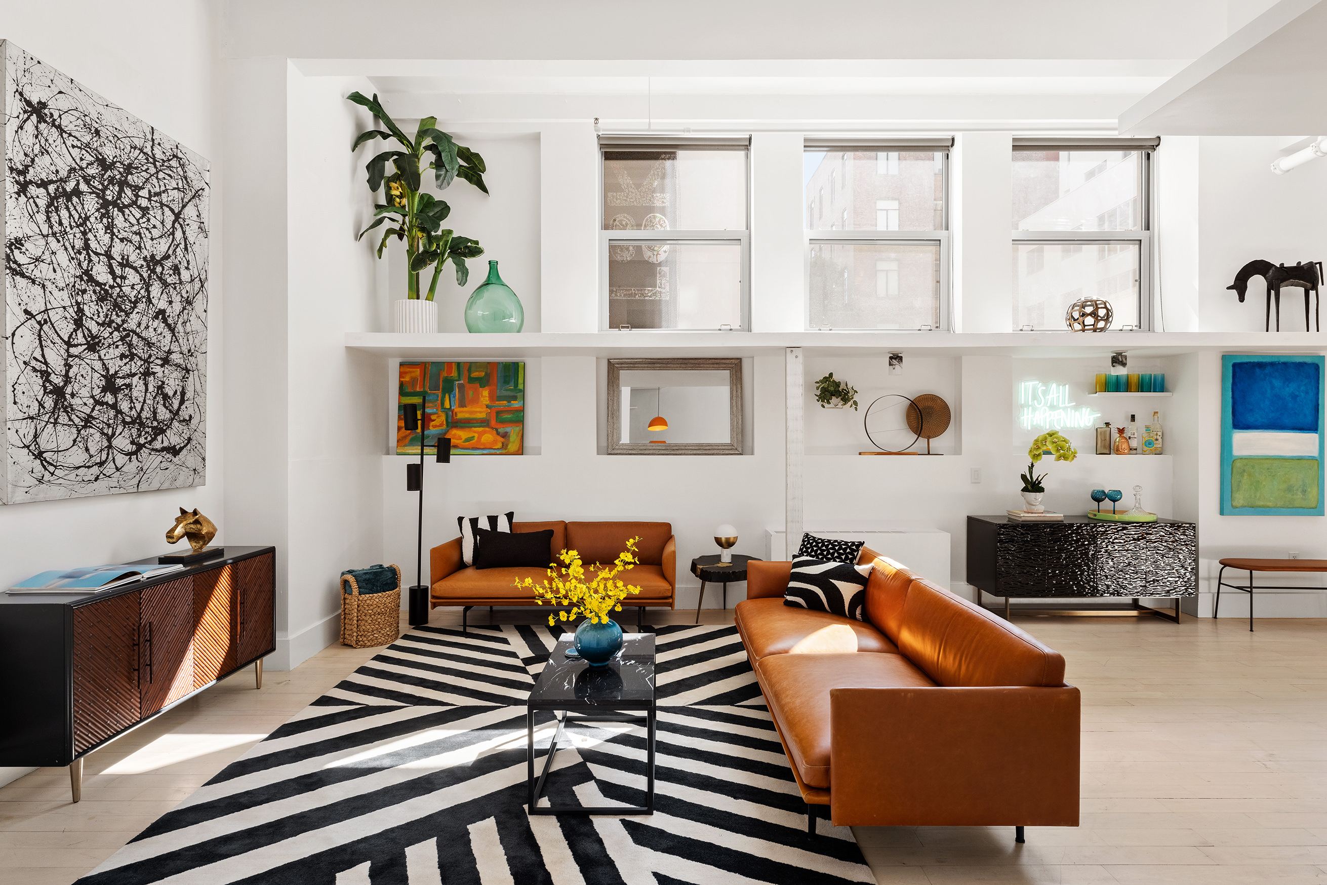 a living room with furniture and a bookshelf