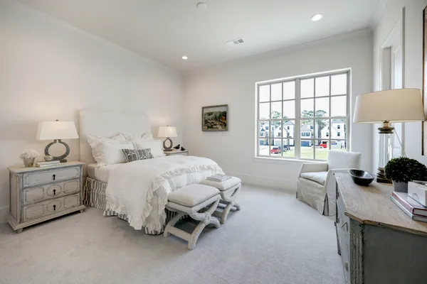 a bed room with a bed and a chair