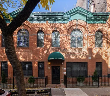 an outdoor view of a house with a garden