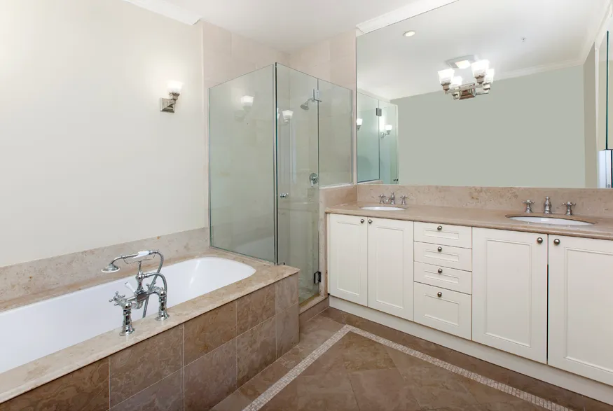 a spacious bathroom with a granite countertop sink a large mirror a shower and a bathtub