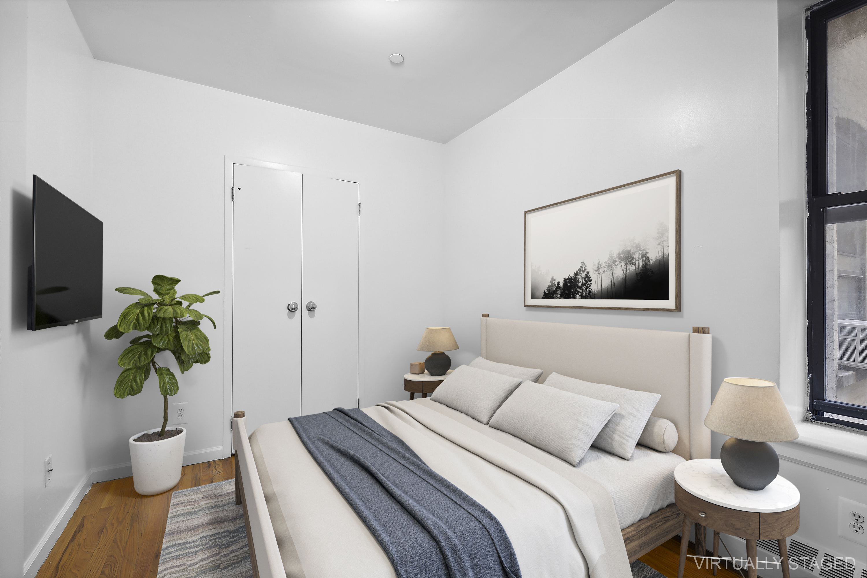 660 St Nicholas Avenue, Unit 33 Manhattan, NY 10030 - Photo 2 of 11 a bedroom with a bed and a potted plant