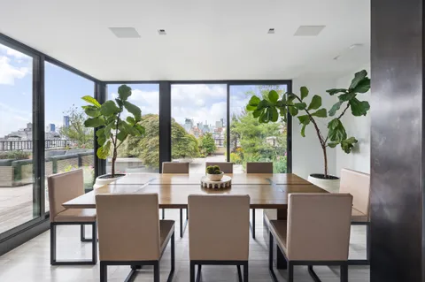 a dining room with furniture window and wooden floor