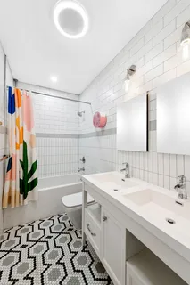 a spacious bathroom with a sink a large mirror and a shower