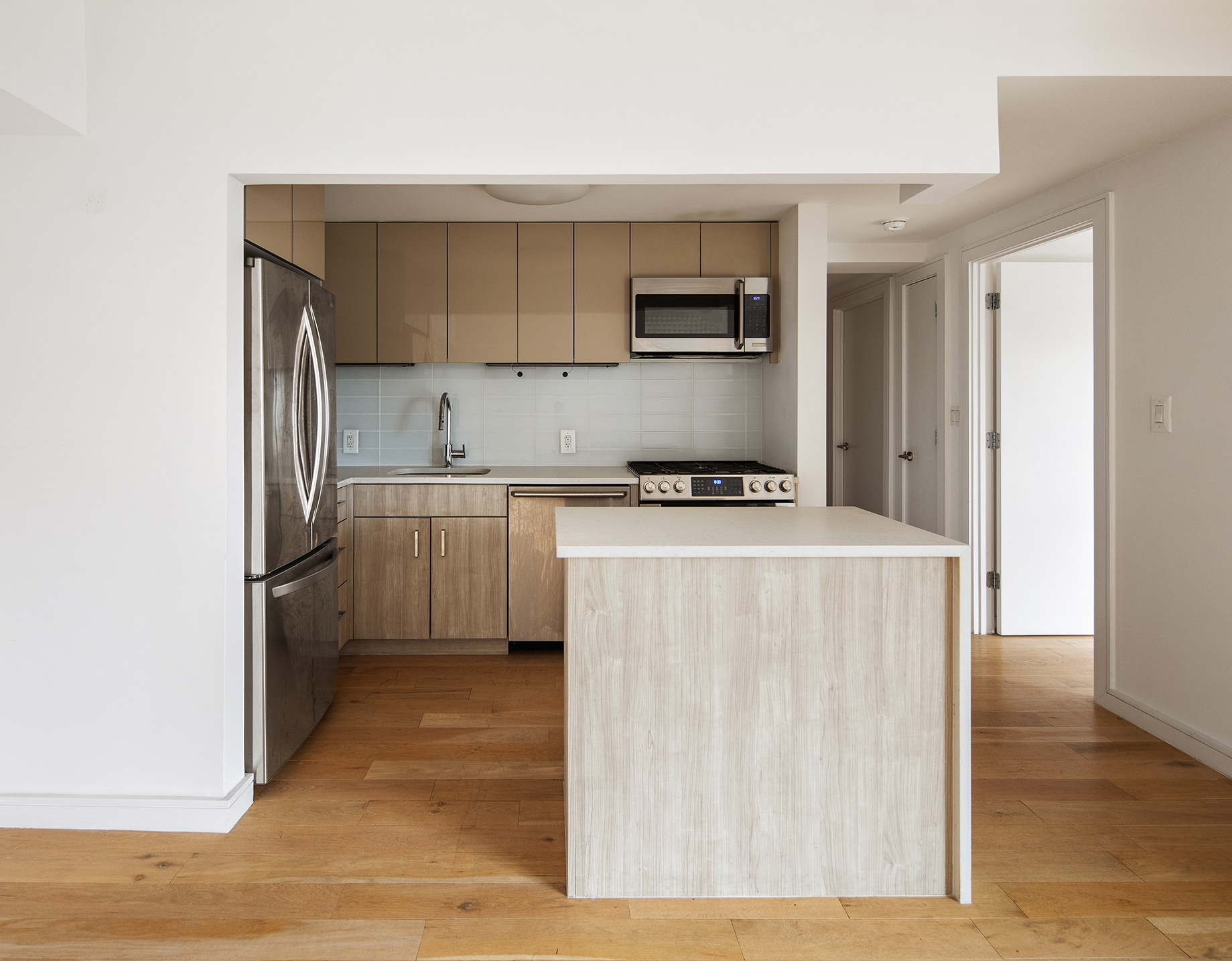 171 West 131st Street, Unit 519 Manhattan, NY 10027 - Photo 2 of 10 a kitchen with stainless steel appliances a stove refrigerator and a sink