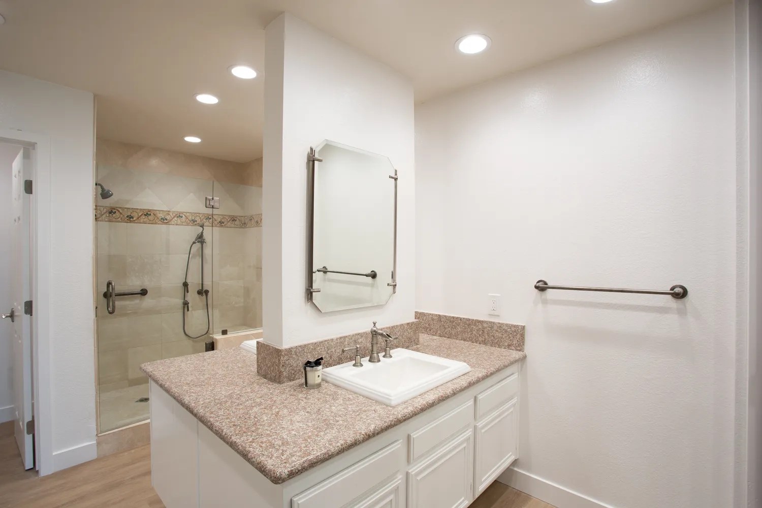 a bathroom with a granite countertop sink and a mirror