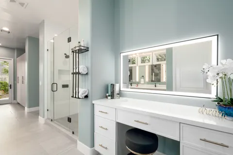 a bathroom with a double vanity sink toilet and shower