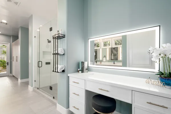 a bathroom with a double vanity sink toilet and shower