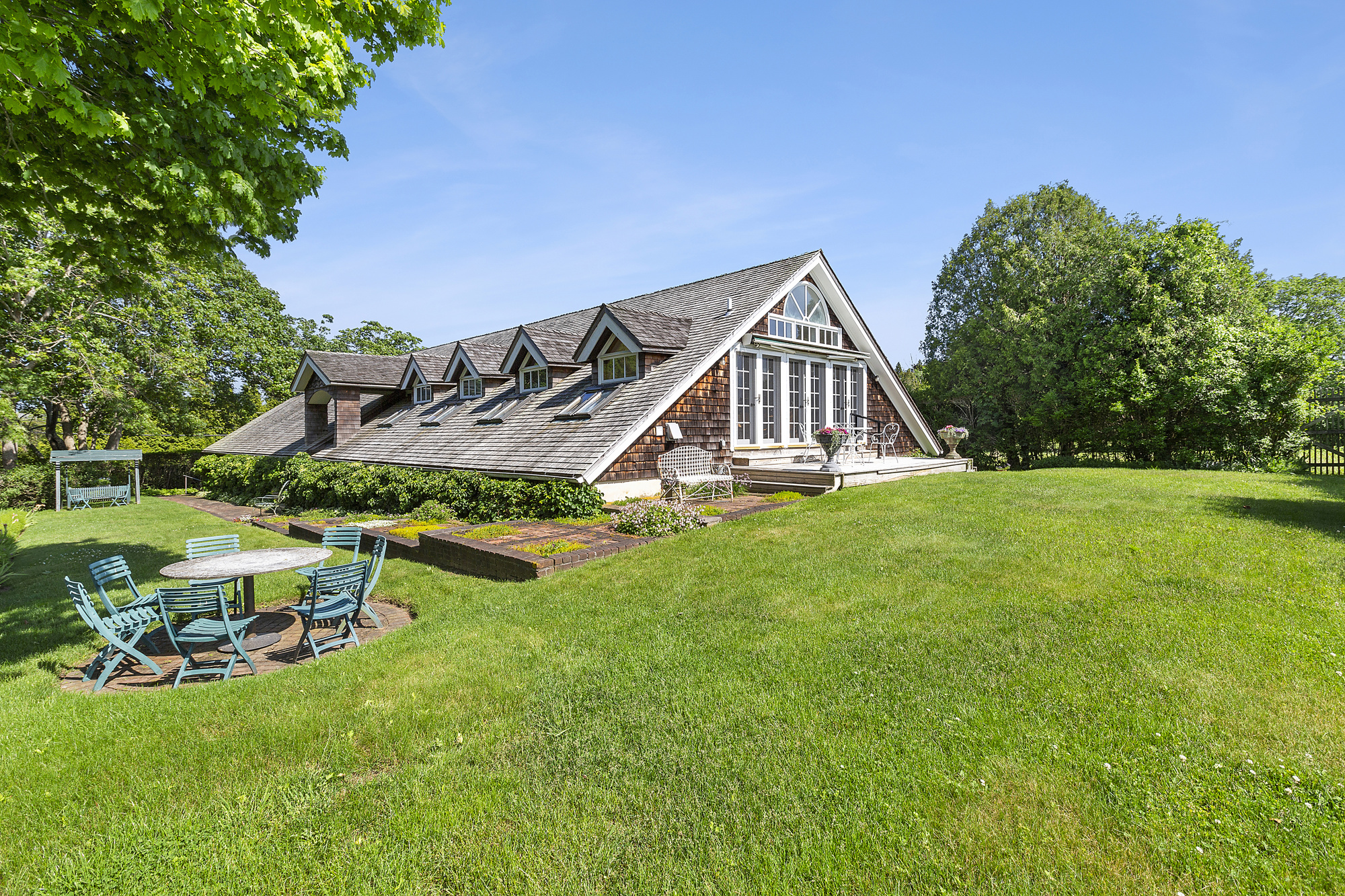 488 Ocean Road Bridgehampton, NY 11932 - Photo 17 of 21 a view of a house with backyard and sitting area