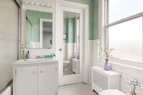 a bathroom with a sink a toilet and a mirror