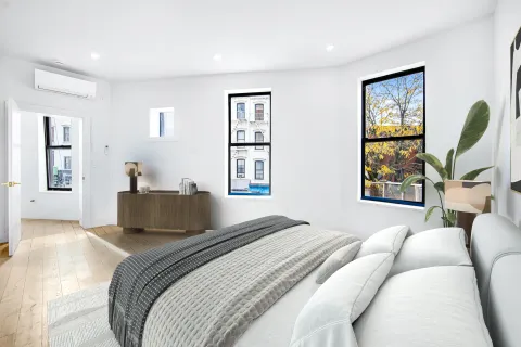 a bedroom with a large bed and a window